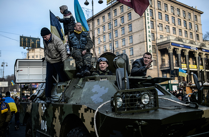 Protestors stand on a military armoured vehicle in central Kiev on February 26, 2014 (AFP Photo / Bulent Kilic)