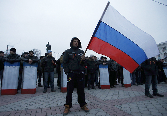 A man holds the Russian flag during a pro-Russian rally in Simferopol, Crimea March 1, 2014. (Reuters / David Mdzinarishvili)