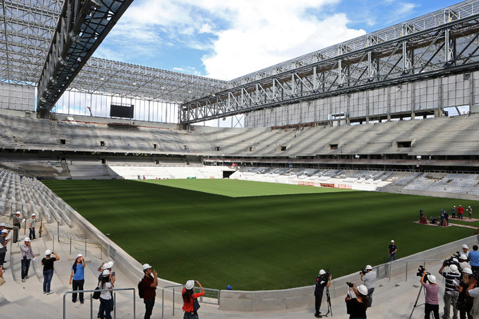 Journalists visit inside the Arena da Baixada soccer stadium as it is being built to host matches of the 2014 World Cup in Curitiba, February 24, 2014.(Reuters / Rodolfo Buhrer)