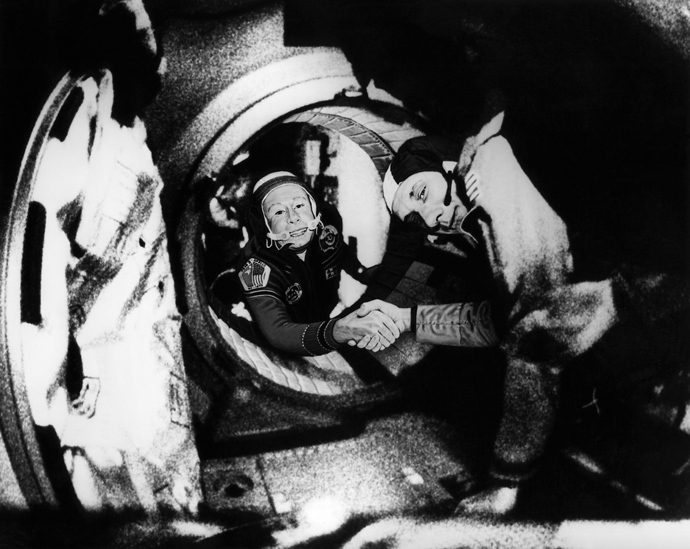 Commander of the Soviet crew of Soyuz, Alexei Leonov (L) and commander of the American crew of Apollo, Thomas Stafford (R), shake hands 17 July 1975 in the space, somewhere over Western Germany, after the Apollo-Soyuz docking manoeuvres (AFP Photo)