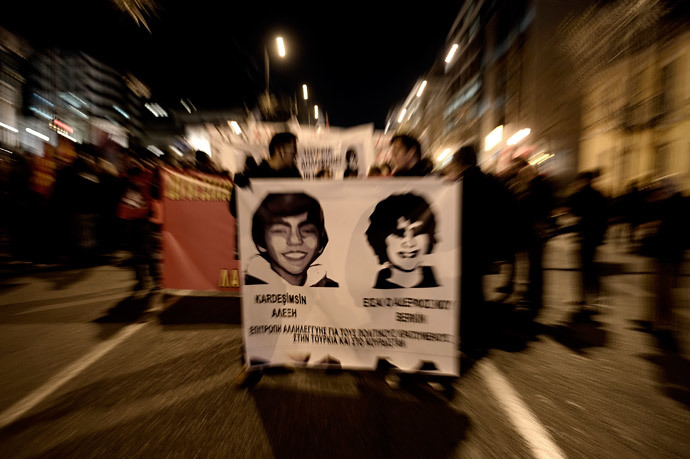 Protesters hold pictures during a demonstration after the death of Berkin Elvan, the 15-year-old boy who who died nine months after he was hit by a tear gas canister while going to buy bread during the protests in Istanbul last year, during a demonstration in Athens on March 13, 2014.( AFP Photo / Aris Messinis)