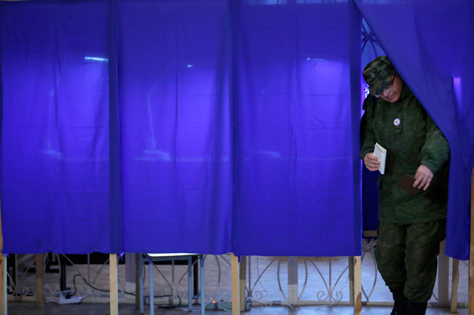 A man leaves a voting booth to cast his ballot during the referendum on the status of Ukraine's Crimea region at a polling station in Sevastopol March 16, 2014.(Reuters / Baz Ratner)