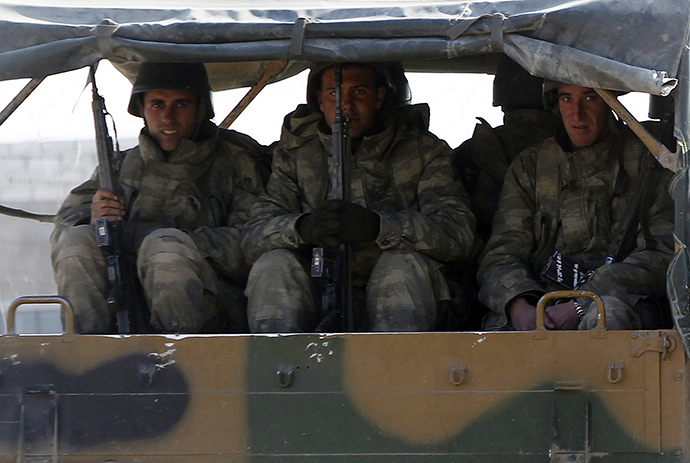 Turkish soldiers sit in a vehicle (Reuters / Amr Abdallah Dalsh)