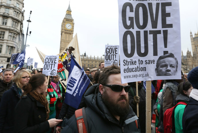 Teachers hold placards and banners during a march in central London March 26, 2014. (Reuters / Paul Hackett)