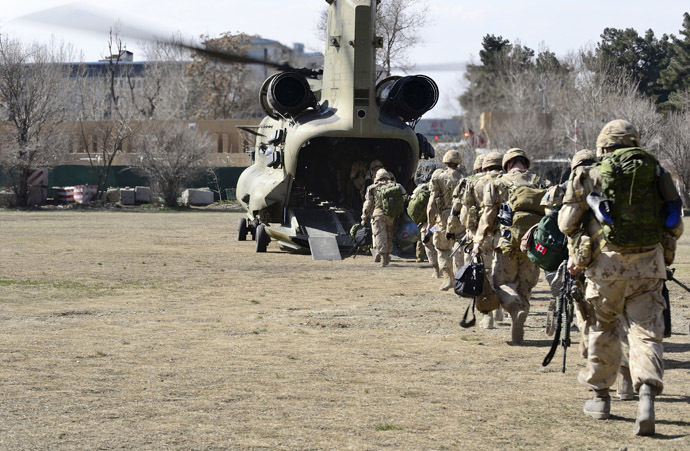 The last Canadians involved in the NATO training mission in Afghanistan board a U.S. Chinook helicopter as they leave the International Security Assistance Force (ISAF) headquarters in Kabul, Afghanistan March 12, 2014. (Reuters)
