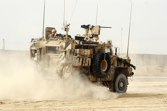 A U.S. armoured vehicle patrols at the site of a suicide attack on a NATO base in Zhari, west of Kandahar province, January 20, 2014. (Reuters)