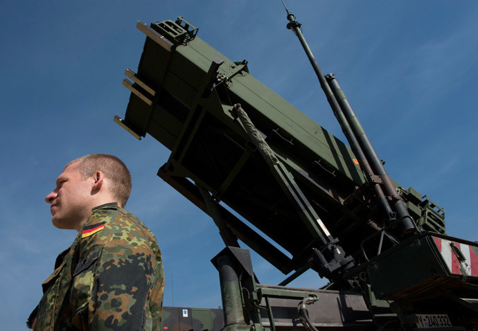 A German soldier stands to attention in front of a German Patriot missile launcher at the Gazi barracks in Kahramanmaras, southern Turkey.(AFP Photo / John Macdougall)
