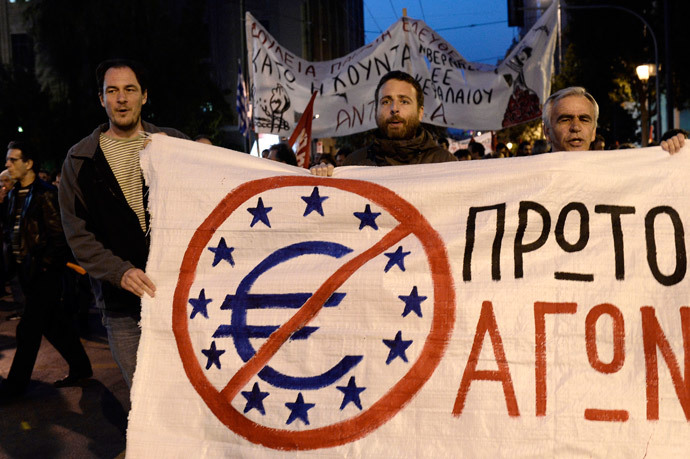 Protesters hold a banner during a demonstration trying to reach the venue of an Informal Meeting of EU Ministers for Economic and Financial affairs in Athens on April 1, 2014. (AFP Photo / Louisa Gouliamaki)