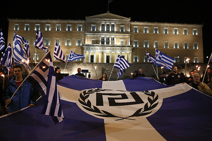 Supporters of Greece's far-right Golden Dawn party protest around a flag during a rally at central Syntagma square in Athens (Reuters / Yorgos Karahalis)