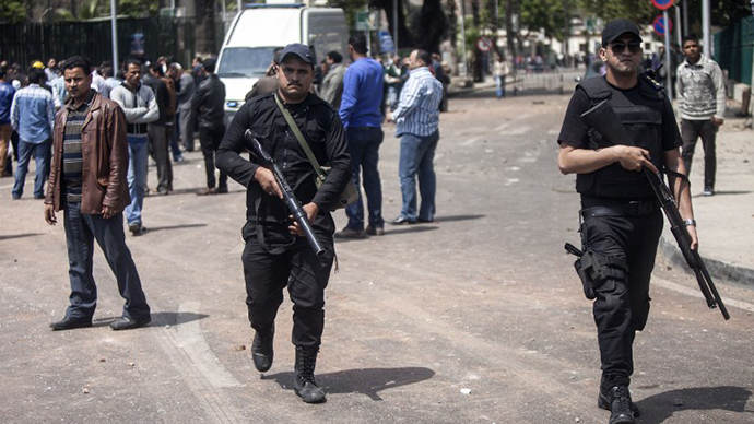 Egyptian security patrol the area after twin bombs struck police posts near Cairo University in the centre of Egypt's capital on April 2, 2014, which was followed by a third blast as police and journalists gathered at the scene. (AFP Photo / Mahmoud Khaled)