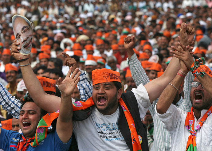 Supporters of Hindu nationalist Narendra Modi, prime ministerial candidate for India's main opposition Bharatiya Janata Party (BJP) and Gujarat's chief minister, cheer as they listen to Modi during a rally in Hiranagar March 26, 2014. (Reuters / Mukesh Gupta)