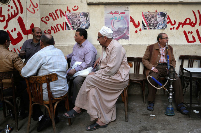 People sit at a cafe near posters of presidential candidate and former Egyptian army chief Field Marshal Abdel Fattah al-Sisi in central Cairo. (Reuters / Asmaa Waguih)