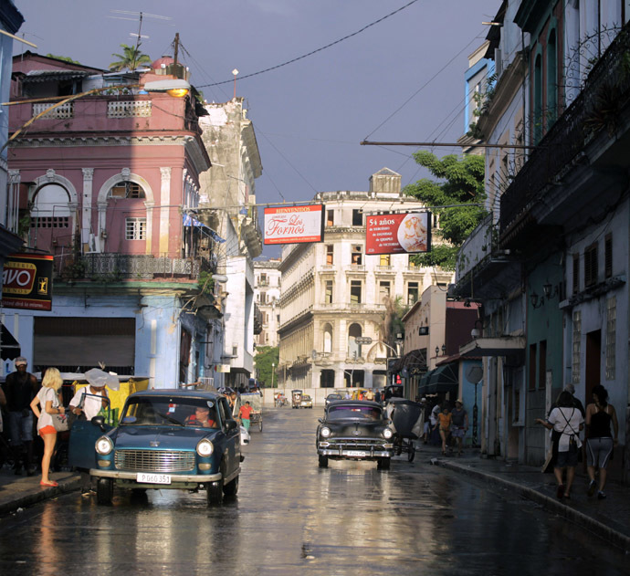 People walk as cars are driven on a street in Havana (Reuters)