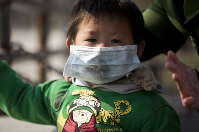 A boy wearing a mask is seen on a street during a hazy day in downtown Shanghai December 3, 2013. (Reuters)