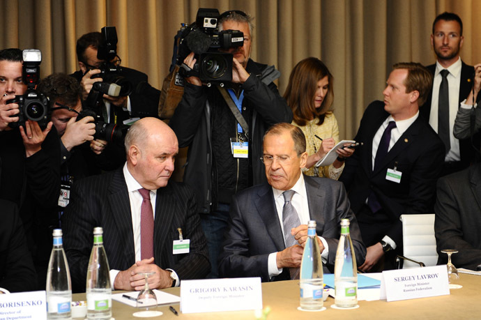 Russia's Foreign Minister Sergei Lavrov (seated R) and Russia's Deputy Foreign Minister Grigory Karasin attend a meeting in Geneva, between representatives from Ukraine, the European Union, Russia and the U.S. on the crisis in Ukraine April 17, 2014. (Reuters/Alain Grosclaude)