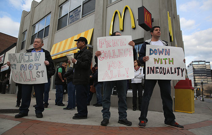 Activists protest for higher wages and free higher education outside a McDonald's restaurant on April 8, 2014 in Stamford, Connecticut. (AFP Photo / Getty Images / John Moore)