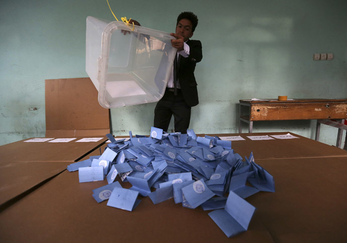 An Afghan election official empties a ballot box for counting at the end of polling in Herat Province, April 5, 2014. (Reuters)