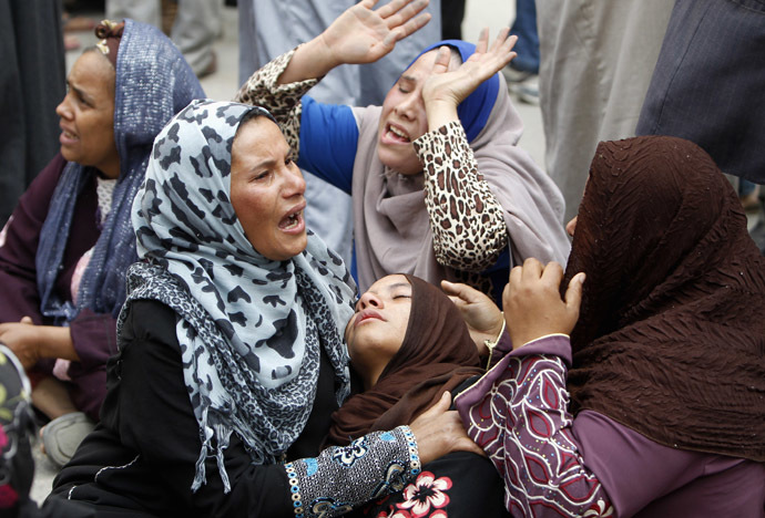 Relatives and families of members of Muslim Brotherhood and supporters of ousted President Mohamed Mursi react after hearing the sentence, in front of the court in Minya, south of Cairo, April 28, 2014. (Reuters)