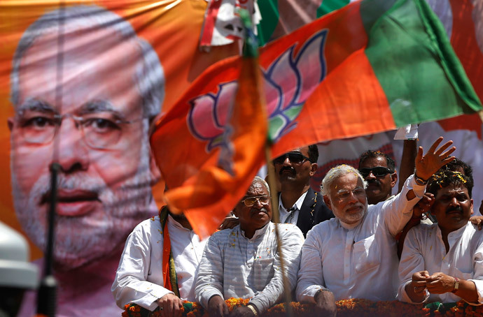 Hindu nationalist Narendra Modi (2-R) prime ministerial candidate for India's main opposition Bharatiya Janata Party (BJP), waves to his supporters as he arrives to file his nomination papers for the general elections in the northern Indian city of Varanasi April 24, 2014. (Reuters / Adnan Abidi)
