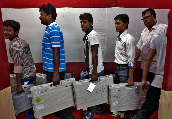 Workers carry electronic voting machines (EVM) at an election material distribution centre ahead of the seventh phase of the general election at Howrah district in the eastern Indian state of West Bengal April 29, 2014. (Reuters / Rupak De Chowdhuri)