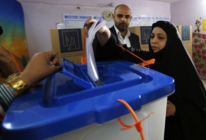 A resident casts her vote at a polling station during parliamentary election in Baghdad April 30, 2014.(Reuters)