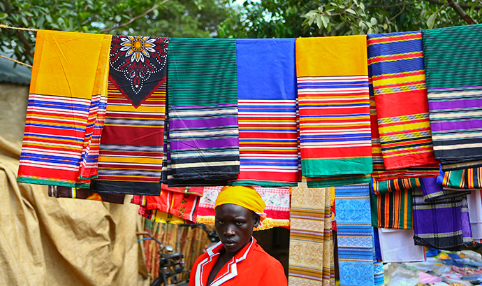 A trader from Bunia in eastern Democratic Republic of Congo sells fabric at a market at the Kyangwali refugee settlement in Hoima district in Western Uganda (Reuters / Edward Echwalu)