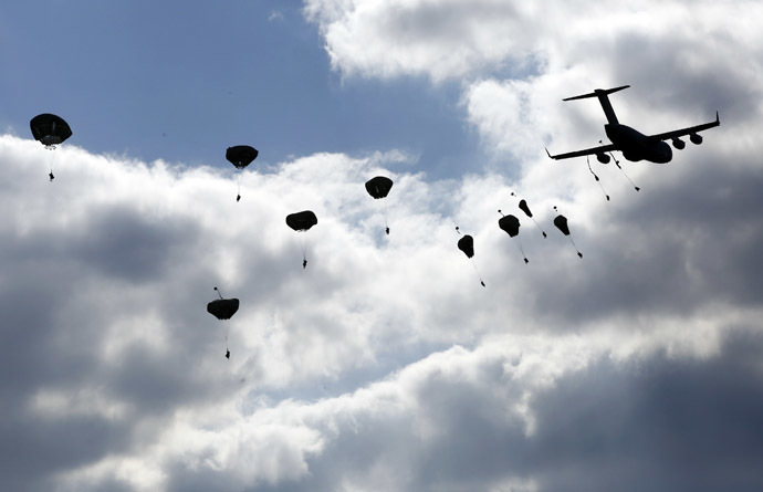 Troops from the U.S. Army's 173rd Infantry Brigade Combat Team parachute from a Boeing C-17 Globemaster III during a NATO-led exercise "Orzel Alert" held together with Canada's 3rd Battalion and Princess Patricia's Light Infantry, and Poland's 6th Airborne Brigade in Bledowska Desert in Chechlo, near Olkusz, south Poland May 5, 2014. (Reuters/Kacper Pempel)