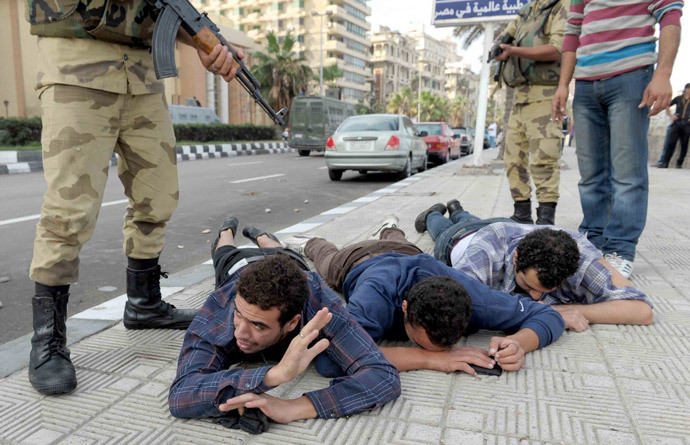 Supporters of the Muslim Brotherhood and of ousted president Mohamed Morsi are detained by Egyptian security during a rally in the port city of Alexandria on November 4, 2013. (AFP Photo / Str)