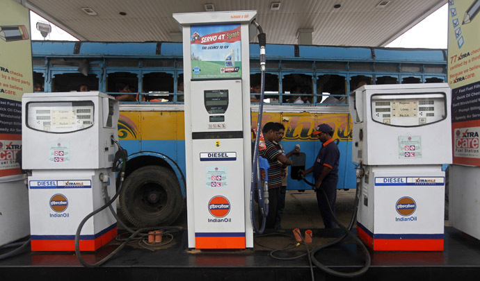 An employee fills diesel in a public bus at a fuel station in Kolkata, India. (Reuters/Rupak De Chowdhuri)