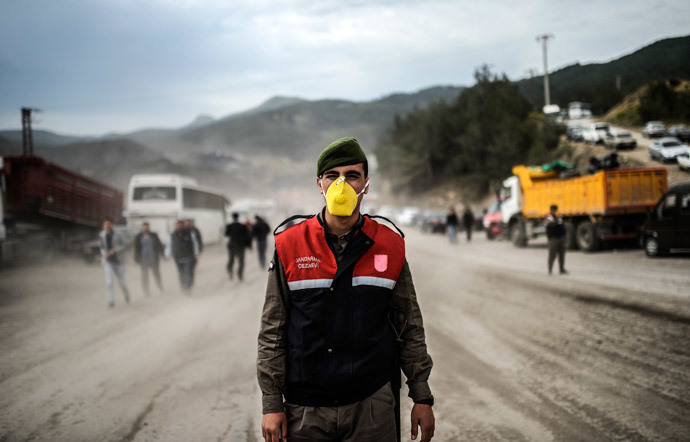 A soldier stands guard on a road leading to the site where 120 workers were believed to remain trapped in a mine after a deadly explosion that claimed the lives of at least 238 people on May 14, 2014 in a coal mine of the western Turkish province of Manisa. (AFP Photo / Bulent Kilic)
