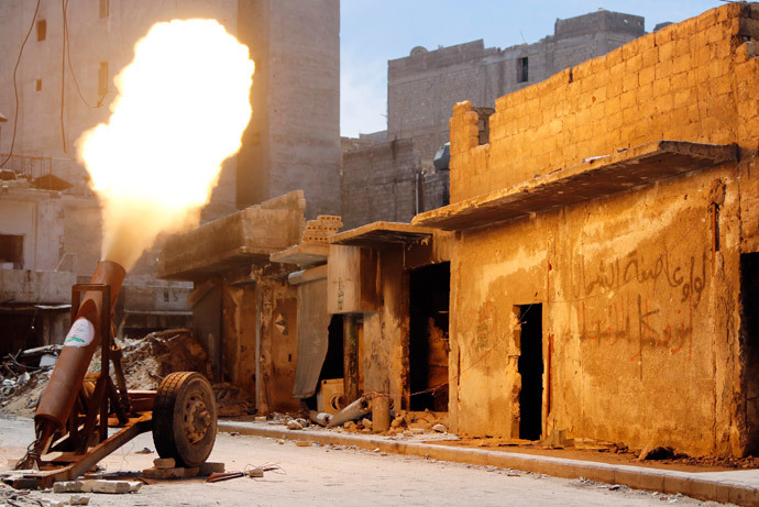 Free Syrian Army fighters fire a self-made rocket towards forces loyal to Syria's President Bashar al-Assad in Bustan al-Basha district in Aleppo May 19, 2014.(Reuters / Hosam Katan)