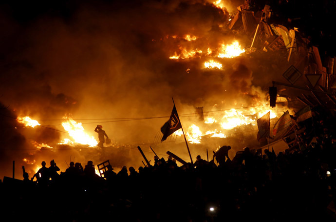 Anti-government protesters stand behind burning barricades in Kiev's Independence Square February 19, 2014. (Reuters/Vasily Fedosenko)