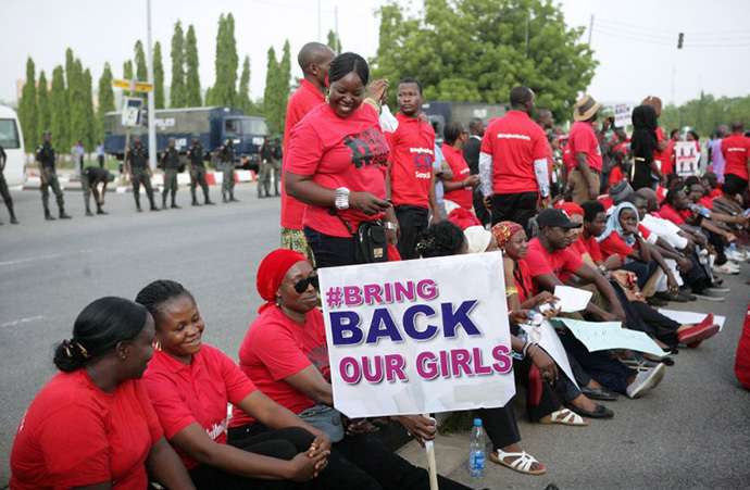 Members of civil society groups and organizations carry placards as the take part in a protest against the abduction of the Chibok schoolgirls, after they were prevented from reaching the president's residence in Abuja on May 22, 2014. (AFP Photo / Wole Emmanuel)