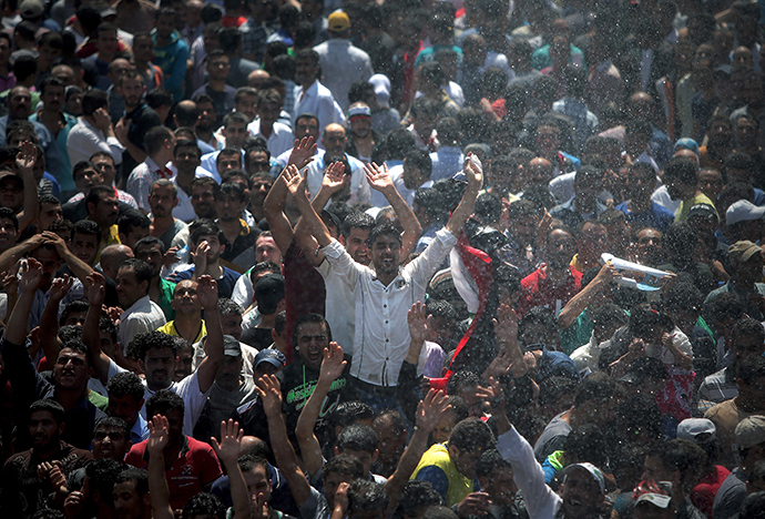Men celebrate, before voting for the upcoming presidential elections in Syria, outside the Syrian Embassy in Yarze east of Beirut on May 28, 2014 (AFP Photo)