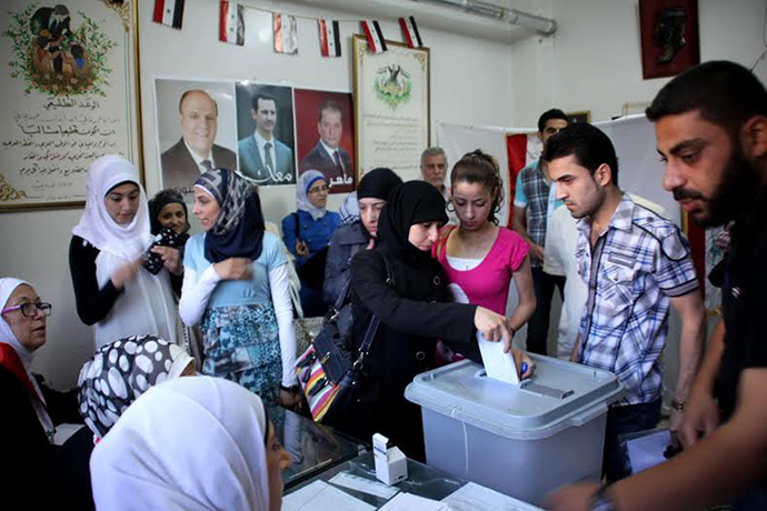 A handout picture released by the official Syrian Arab News Agency (SANA) on June 3, 2014 shows citizens voting in presidential election at a polling station in a regime-held area in Aleppo (AFP Photo / SANA)