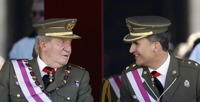 Spain's Crown Prince Felipe smiles next to his father King Juan Carlos (L) as they attend a ceremony marking the bicentennial of the creation of the order of Saint Hermenegildo at the Monastery of San Lorenzo de El Escorial, outside Madrid June 3, 2014. (Reuters/Sergio Perez)