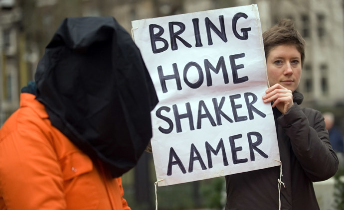 A protestor holds up a sign calling for the release of Shaker Aamer from the Guantanamo prison during a demonstration in central London, on January 11, 2010. (AFP Photo/Leon Neal)