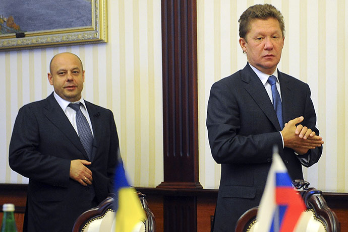This handout picture taken and released by the Ukrainian Prime Minister press-service on June 16, 2014, shows Ukrainian Minister of Energy and Coal Industry Yuriy Prodan (L) and head Russian state gas firm Gazprom Alexei Miller (R) arriving for talks over Russia's gas supply to Ukraine, in Kiev. (AFP Photo / Andrew Kravchenko)