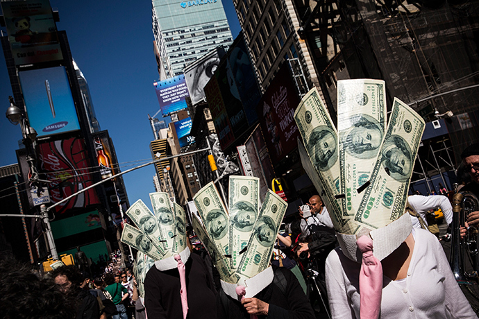 Occupy Wall Street protesters wearing masks made out of enlarged dollar bills act in a short skit in Times Square on September 17, 2013 in New York City (AFP Photo / Andrew Burton)