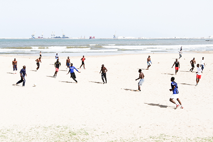 A group of migrants, who managed to scale Melillaâs wall, play football on a beach of the Spanish enclave. Photo by @TomasoClavarino