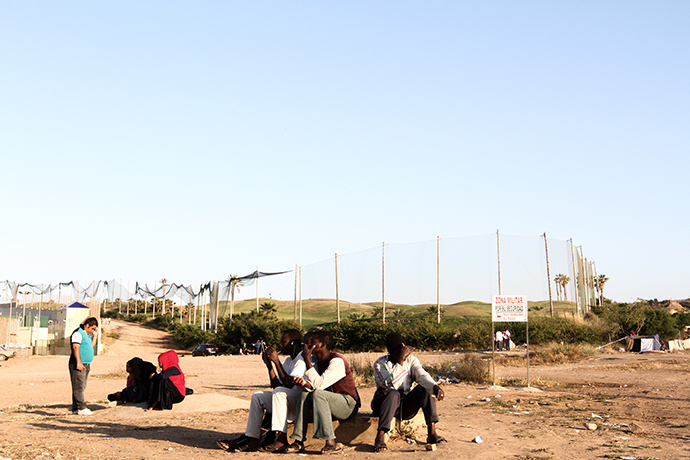 Malian migrants waiting for dinner in front of Melillaâs CETI (Centro de Estancia Temporal de Inmigrantes). Photo by @TomasoClavarino