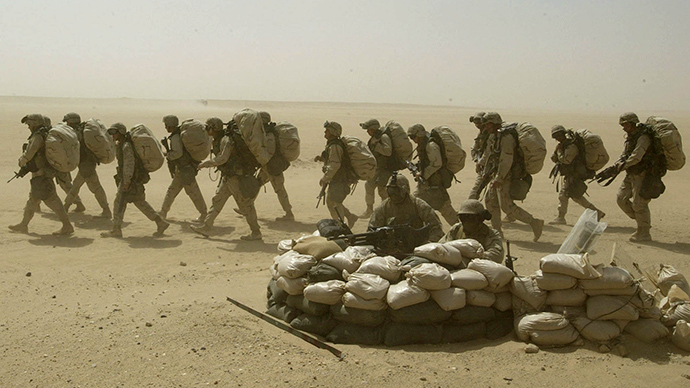 U.S. marines walk in full combat gears during a drill for infantry tactics in a stormy Kuwaiti desert on March 13, 2003 (Reuters / Oleg Popov)