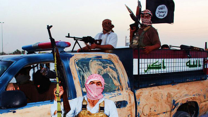 Militants of the Islamic State of Iraq and the Levant (ISIL) riding in a captured vehicle left behind by Iraqi security forces at an unknown location in the Salaheddin province. (AFP Photo)