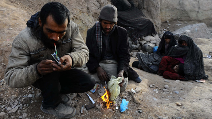 An Afghan drug addict smokes heroin in the city of Herat. (AFP Photo/Aref Karim)