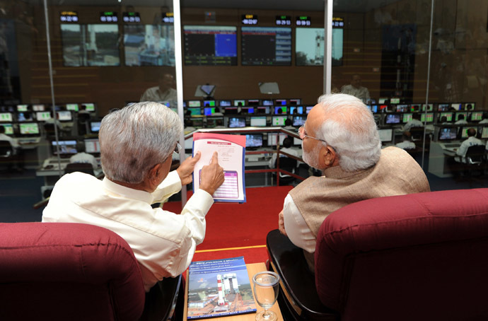In this photograph released by the Press Information Bureau (PIB) on June 30, 2014, Indian former ISRO scientist B.N Suresh (L) briefs Prime Minister Narendra Modi during the successful launch of a Polar Satellite Launch Vehicle (PSLV) at the programme's mission control in Sriharikota. (AFP/PIB)