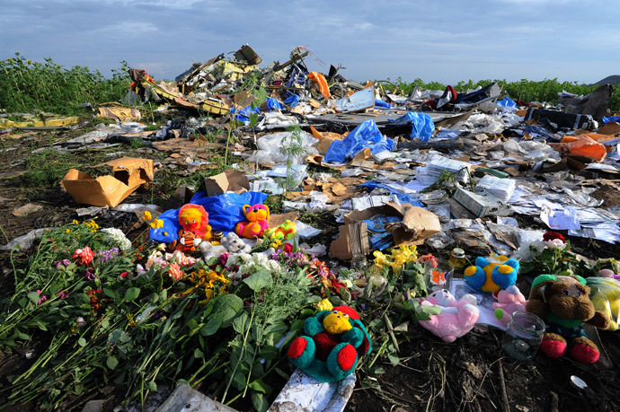 Flowers and plush toys are left at the site of the crash of a Malaysia Airlines plane carrying 298 people from Amsterdam to Kuala Lumpur in Grabove, in rebel-held eastern Ukraine, on July 19, 2014. AFP Photo / Dominique Faget)