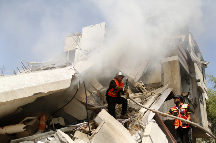 Palestinian firefighters extinguish a fire following what witnesses said was an Israeli air strike on a house, in Gaza City July 23, 2014. (Reuters)