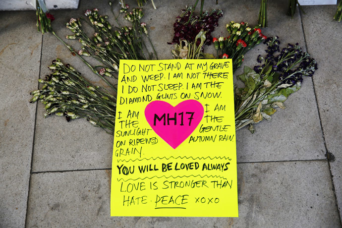 Flowers and messages for the victims of flight MH17 are seen outside Malaysia's High Commission in central London July 22, 2014 (Reuters/Luke MacGregor)