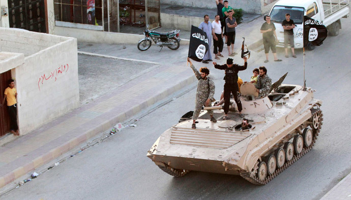 Militant Islamist fighters take part in a military parade along the streets of northern Raqqa province (Reuters / Stringer)