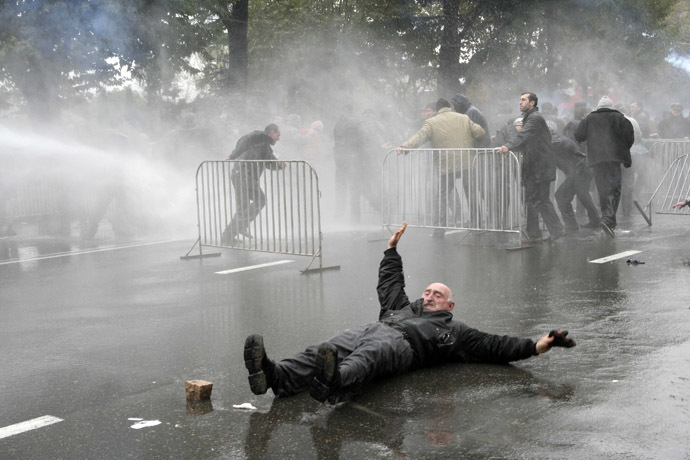 An opposition supporter lies on the road during clashes with police in central Tbilisi November 7, 2007. (Reuters)